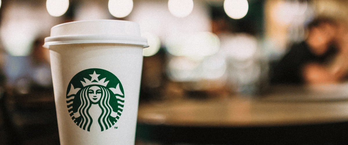 branding for small businesses blog post - A Starbucks cup close up in a Starbucks café